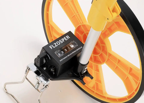 Smooth Rolling Measuring Wheel With Durable Rubber Tire And Mechanical Counter For Nailing Yard Surveys Up To Nine Thousand Nine Hundred Ninety Nine Feet Light Alloy Frame Collapses Fast For Zero Fuss Stashing In Bright Yellow