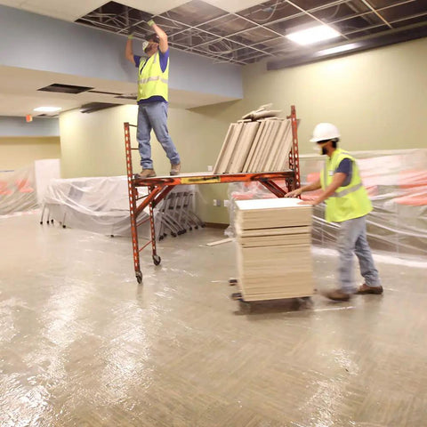 Workers using Heavy Duty Carpet Shield Film 36 Inch By 500 Feet 2 Mil Tear Resistant Masking Film Keeps Rugs Protected From Spills Dirt
