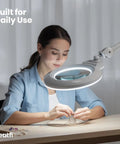 Woman using XL Bifocal LED Magnifying Lamp With 7 Inch Acrylic Lens 2.25x And 6x Magnification, 1600 Lumens Dimmable for crafting