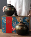 Super Sleek Large Ceramic Tea Canister With Airtight Lid For Loose Tea Leaves Coffee Beans And Candy Kitchen Food Storage Jar displayed on a colorful box with decorative details.