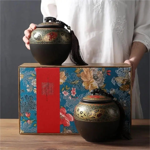 Super Sleek Large Ceramic Tea Canister With Airtight Lid For Loose Tea Leaves Coffee Beans And Candy Kitchen Food Storage Jar displayed on a colorful box with decorative details.