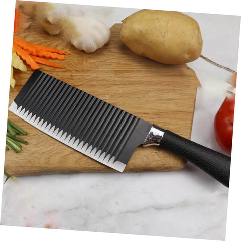SOLUSTRE wavy chopper knife on cutting board with potatoes and garlic; stainless steel blade, black handle