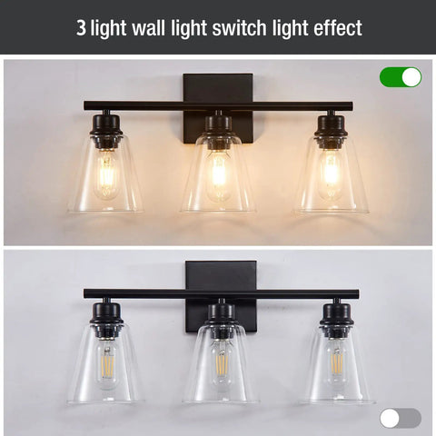 Three Light Black Vanity Lights Over Mirror, On Trend Modern Farmhouse Industrial Bathroom Fixtures With Metal Base And Clear Glass Shades, Wall Sconce Lighting For Bathrooms, Bulbs Not Included, showing illuminated and unlit versions.