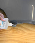 Applying Cyanoacrylate Glue With Activator Set Instant Grab CA Glue And Super Glue Accelerator on black plastic surface