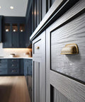 Six Pack 3 Inch Antique Brass Cabinet Cup Pulls With Hand Hammered Texture And Smooth Curved Edges installed on kitchen drawers