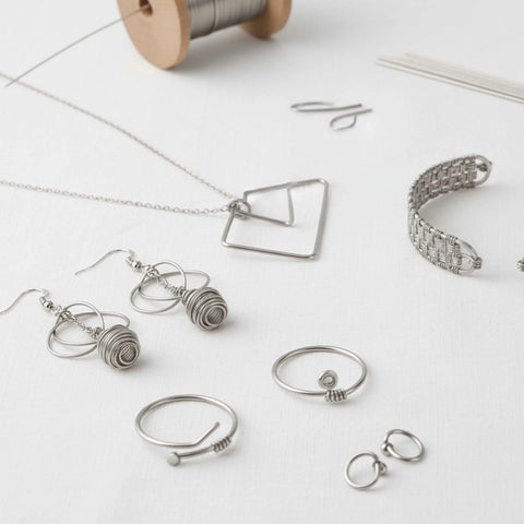 Silver-tone jewelry findings set: hooks, rings, chain, wire-frame pendant, and bracelet components.