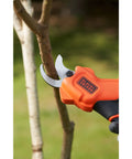 Premium 18V Cordless Hand Grass Trimmer With 2Ah Lithium Battery cutting a small branch for precise garden maintenance.