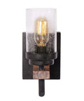 Rustic Wall Light Sconce With Seeded Glass Shade And Vintage Edison Bulb Look mounted on dark wood backplate