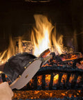 Large Wood Fire Bellows With Hanging Strap Cast Nozzle For Outdoor Camping And BBQ Grill Chimney Hand Pump Fireplace Tool Accessories Premium Leather Heat Resistant Durable Solid Wood Construction being used to stoke a fire in a fireplace