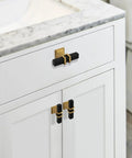 Two Pack Square Black And Gold T Bar Cabinet Handles on white cabinet with marble countertop, stainless steel single hole center mount