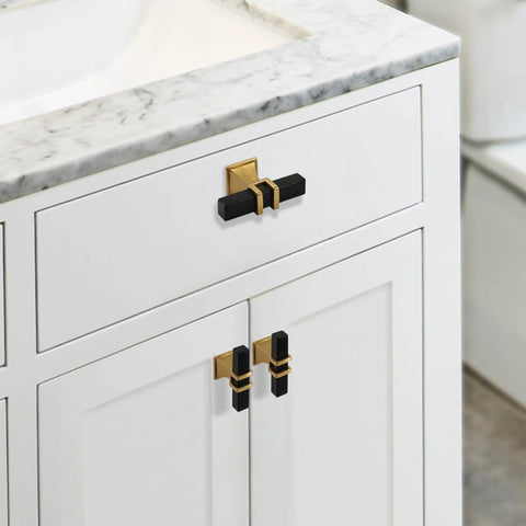 Two Pack Square Black And Gold T Bar Cabinet Handles on white cabinet with marble countertop, stainless steel single hole center mount