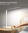 LED Desk Lamp With USB Charging Port, 700 Lumens Dimmable Touch Control Table Lamp on a bedside table, person touching base