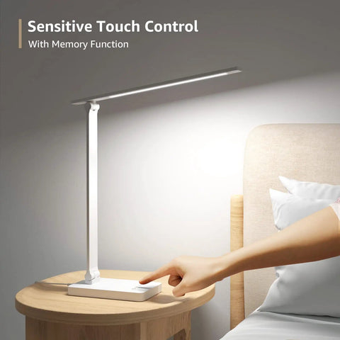 LED Desk Lamp With USB Charging Port, 700 Lumens Dimmable Touch Control Table Lamp on a bedside table, person touching base