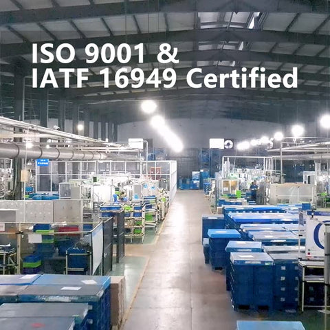 Factory interior showing ISO 9001 & IATF 16949 certified operations with machinery and storage bins.
