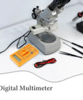 Digital Multimeter With Buzzer Three And A Half Digit LCD Display Voltage Current And Resistance Tester next to microscope and tools