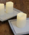 Outdoor IP44 Flameless LED Pillar Candles Set Of 3 With Remote And Timer Warm White Weather Resistant Plastic Candles That Wont Melt Waterproof 3 By 4 Inches Battery Operated on two plates