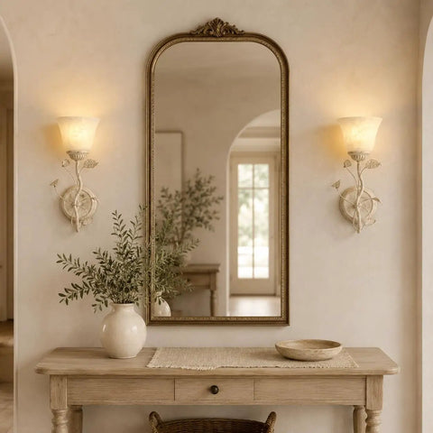 Folux Battery-Operated Vintage White Flower Wall Sconce Set of 2 illuminating a mirror above a wooden console table.
