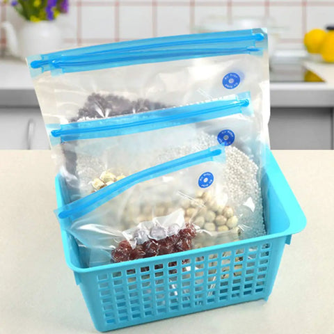 Handheld Vacuum Sealer For Food Storage Bags With T-Style Manual Pump. Space Saving compact design with sealed bags in a blue basket.