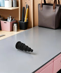 Rugged Rubber Grommet Kit For Automotive Wiring Harnesses And Wire Bundles Fits Three Eighths To One Inch Wires Durable Black Seals For DIY Install And Vehicle Cabling That Works Like A Charm. Black rubber grommet on workbench for 3/8 to 1 in wiring