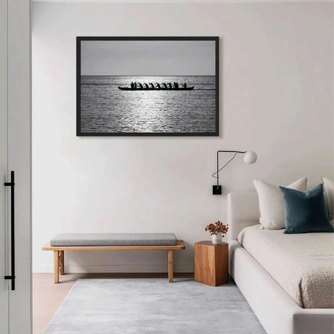 Rowing Team Silhouette Canvas Print With Black Frame, Modern Ocean Landscape Wall Art displayed above sofa in living room