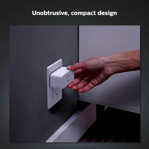 Hand plugging Hue Smart Plug into a wall socket, turning any lamp into a smart light with no fuss via voice or app control