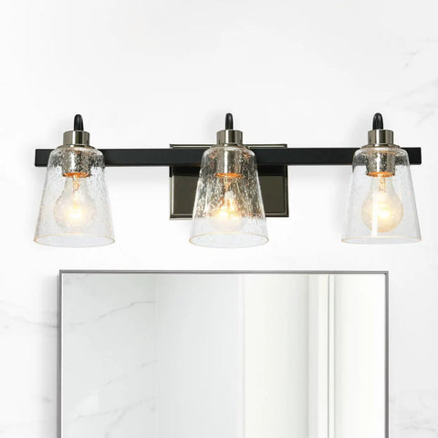 Three Light Vanity Fixture With Seeded Glass Diffusers Matte Black Finish With Polished Nickel Accents Sleek Industrial Vibe