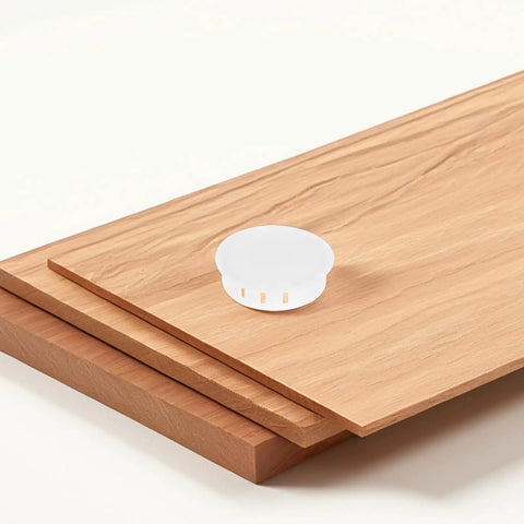 2 Inch Round White Plastic Screw Hole Plugs With Flush Snap In Locking Covers Matte Finish 20 Pack on wooden surface