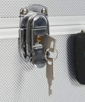 Close-up of lock and key on sturdy aluminum tool case with six extendable trays lockable portable organizer for tools durable silver storage box.