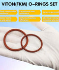 Close-up of two Viton O rings on glove, part of Viton O Ring Kit With 396 Pieces And 30 Sizes Metric O Rings Assortment 75A Durometer FKM Sealing Kit For Hydraulic Automotive Engine And Plumbing Repair Pro Grade Heavy Duty