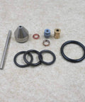 Waterjet maintenance kit components: conical nozzle, steel rod, brass fitting, blue bushing, copper washers, and O-rings