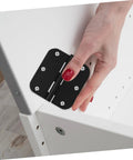 Close-up of a black rounded-corner iron door hinge mounted on a white cabinet door