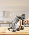 Sturdy Pot Lid Storage Rack With Seven Adjustable Compartments For Countertops And Cabinets Keeping Bakeware Pan Covers And Plates Super Secure in black.