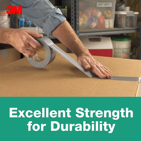 Person using Heavy Duty Duct Tape That Is The Go To For Everyday Fixes With Beast Mode Strong Adhesive And Waterproof Backing 1.88 Inch By 60 Yard Multi Use Tape For Bundling Cords Patching And Reinforcing Durable And Long Lasting to seal a cardboard box in a garage.