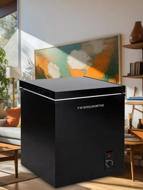 Hella Spacious 7.0 Cu.Ft Chest Freezer In Bold Black in modern home setting, featuring adjustable thermostat and smooth-slide baskets.