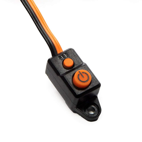 Close-up of Firma 85A Brushless Smart ESC And 3300Kv Sensorless Motor Combo power switch, black housing with orange buttons