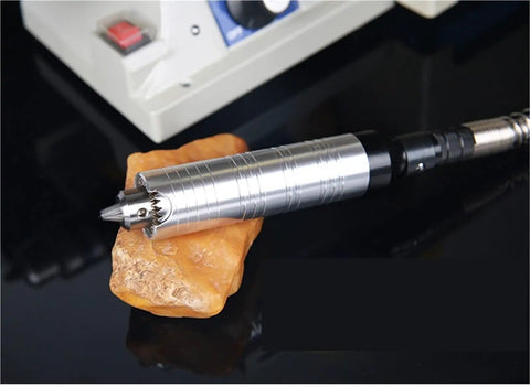 Jade Carving Machine Bench Grinder Polisher Cutting Tool Electric Stone Workbench with silver handle on stone base.