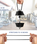 22 lb load capacity elastic strap being stretched to 18 inches by hands, gym equipment in background