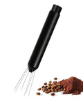 Next Level Espresso Distribution Tool With Retractable Stainless Steel Needle For Portafilter Clump Crushing And Fluffy Coffee Beds next to ground coffee.