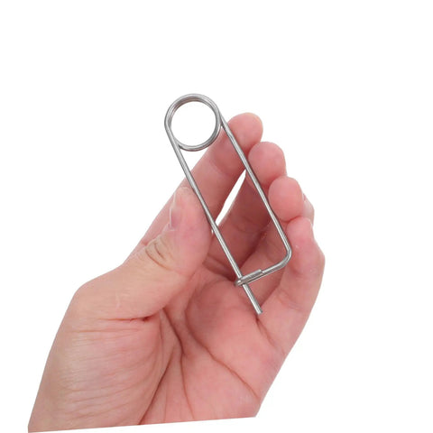 Heavy Duty Stainless Steel Brooch Cotter Safety Spring Pins For Quick Lock Farm Hitch and Industrial Use held in hand.