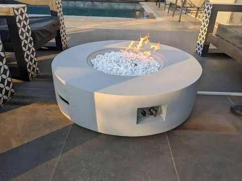 Round fire pit with Fire Pit Burner Valve System Kit With Flame Failure Safety Valve And Push Button Igniter in outdoor patio setting.