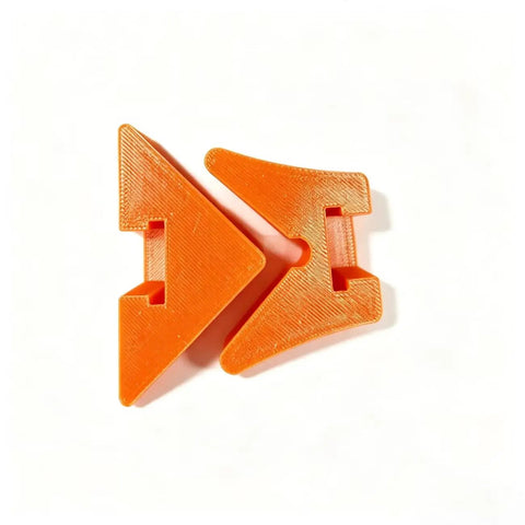 Two orange plastic Rock Solid 90 Degree Corner Clamp Adapter pieces for woodworking right angle jig assembly.