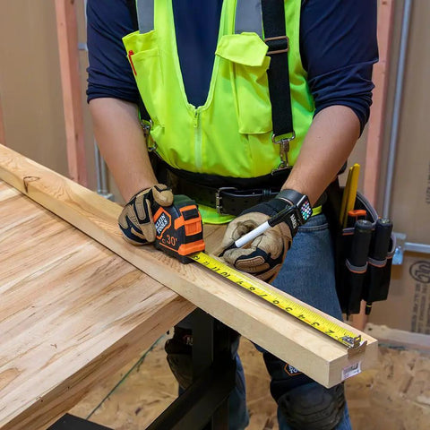 Heavy Duty Tape Measure With 30 Foot Double Hook, Double Sided Nylon Reinforced Blade, 13 Foot Standout in use on construction site