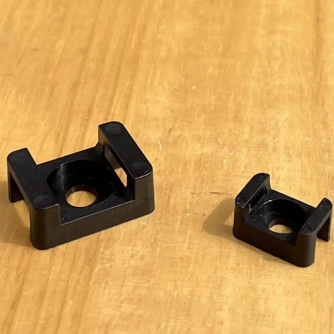 Two Size Cable Tie Saddle Base Mounts For Securing Cables Wires And Cords 100 Piece Set Screw In Install on wood surface