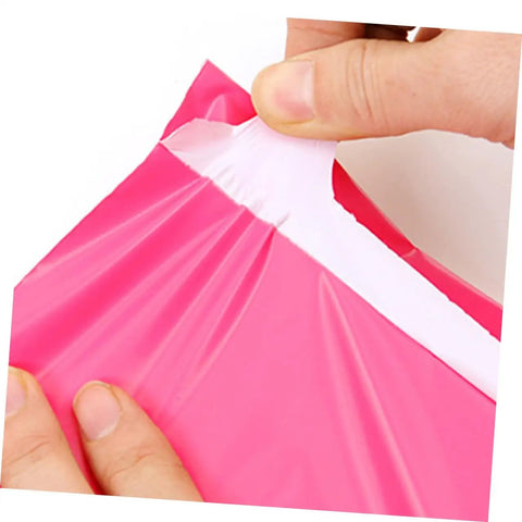 Hands sealing Thickened Waterproof Pink Poly Mailer Bags 17x30cm Bulk Pack of 100, showing durable adhesive closure