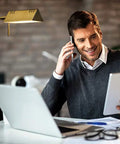 Man working at desk illuminated by Dimmable LED Pharmacy Floor Lamp With 12W LED Full Range Dimming 360 Degree Swing Arms Adjustable Height