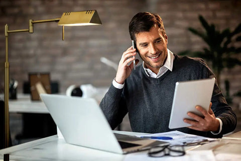 Man working at desk illuminated by Dimmable LED Pharmacy Floor Lamp With 12W LED Full Range Dimming 360 Degree Swing Arms Adjustable Height