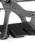 Close-up view of the Beefed Up Carbon Fiber Chassis Kit For Rock Crawling Rigs With High Clearance And 3Mm Laser Cut Build. Focus on mounting brackets and structure.