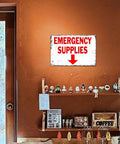 12 X 8 Inch Aluminum Emergency Supplies Directional Metal Sign Rugged Workhorse Built Tough Weatherproof Arrow Sign For Home, Garage, Warehouse, And Bunker With Easy Hanging Installation. Wall-mounted emergency supplies arrow sign in a room