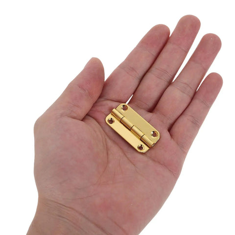 Person holding Antique Gold Rounded Corner Iron Hinges For Wooden Jewelry Boxes And Cabinets Four Hole Vertical Mount Enhanced Load Support