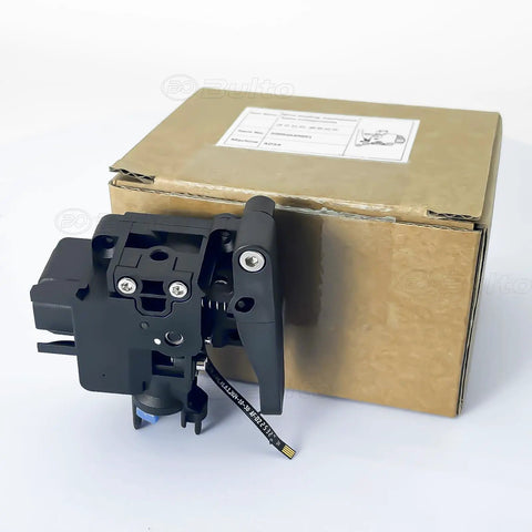 AD5X Filament Feeding Assembly For AD5X 3D Printer - Wire Feeding Mechanism And Extruder Parts Replacement, Compatible With AD5X Extruder, OEM-Grade Upgrade For Damaged Cutter Lever And Feeding Issues. Black plastic extruder module with ribbon cable next to box